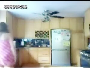 A young woman and her dog in the kitchen