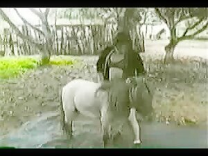 Horse fucks a woman