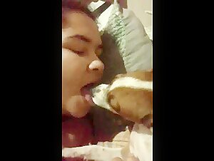 My girlfriend affectionately kisses the dog